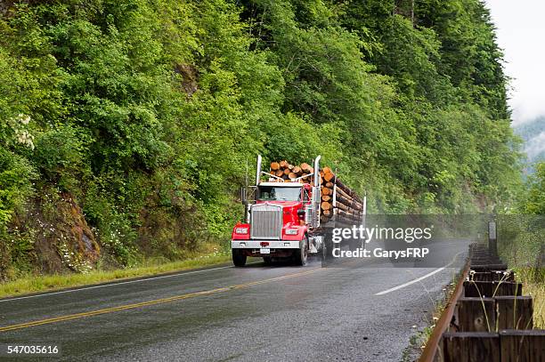 loaded log truck on rural washington state road port angeles - port angeles washington state stock pictures, royalty-free photos & images