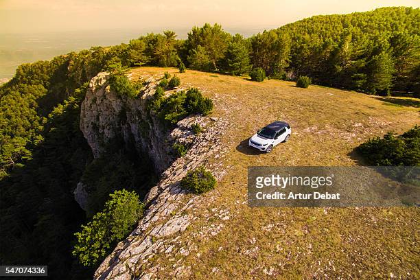 suv car place on the top of mountain with beautiful view of the catalan pyrenees on sunset light during a road trip to discover the hidden places of the region. - high section bildbanksfoton och bilder