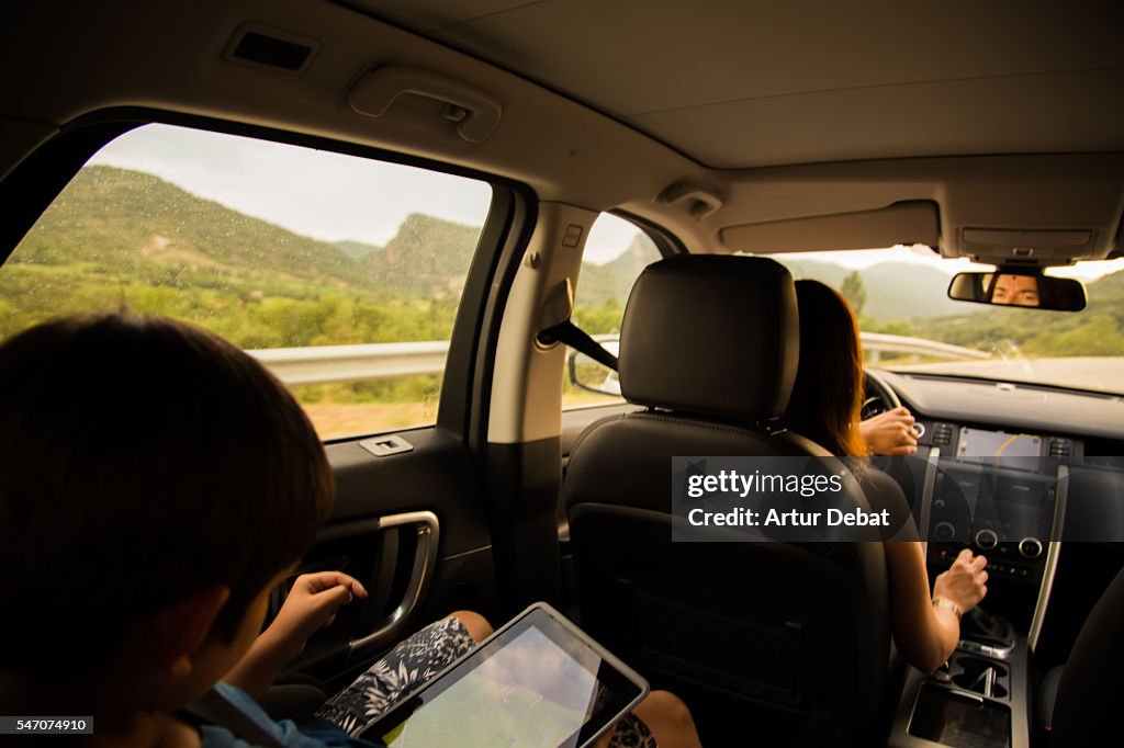 Family mother driving a suv car during a road trip travel through the Catalan Pyrenees roads.