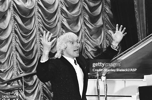 Jimmy Savile, as the compere, introduces Gerry & The Pacemakers during rehearsals of the talent show scenes for Jeremy Summers' musical film, 'Ferry...