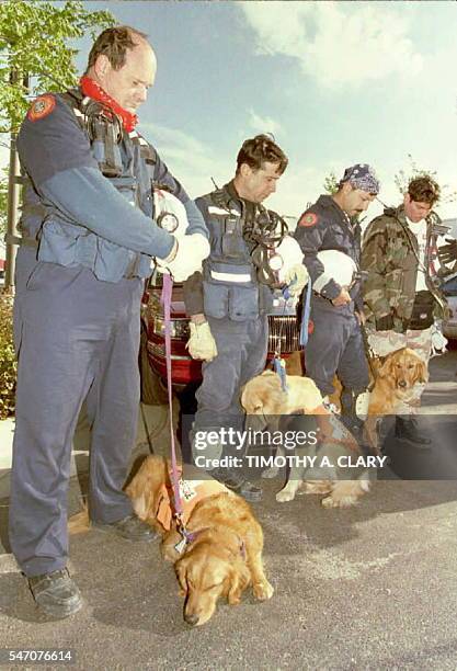 Rescue workers from Dade County Florida Fire and Rescue gather with their golden retreiver search dogs outside of the Oklahoma City Federal Building...