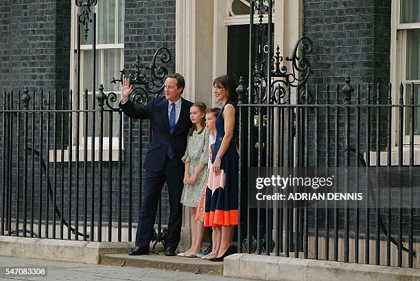 Outgoing British prime minister David Cameron waves outside 10 Downing Street with his family his daughter Nancy Gwen, son Arthur Elwen, daughter...