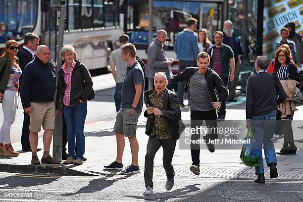 Actors Ewan McGregor and Ewan Bremner run on the set of the Trainspotting film sequel on Princess Street on July 13, 2016 in Edinburgh, Scotland. The...