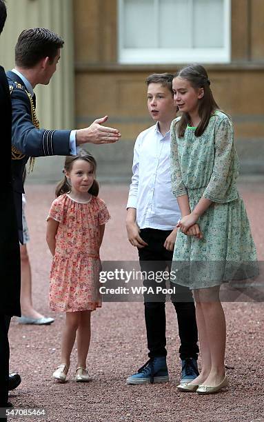 The children of Samantha and David Cameron, Nancy Elwen and Florence are greeted as they arrive at Buckingham Palace where their father will have an...