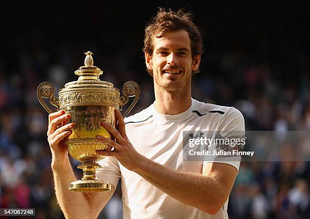 Andy Murray of Great Britain lifts the trophy following victory in the Men's Singles Final against Milos Raonic of Canada on day thirteen of the...