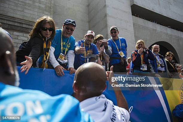 118th Boston Marathon: Rear view of USA Meb Keflezighi victorious after winning race on Boylston Street. Boston, MA 4/21/2014 CREDIT: Damian...