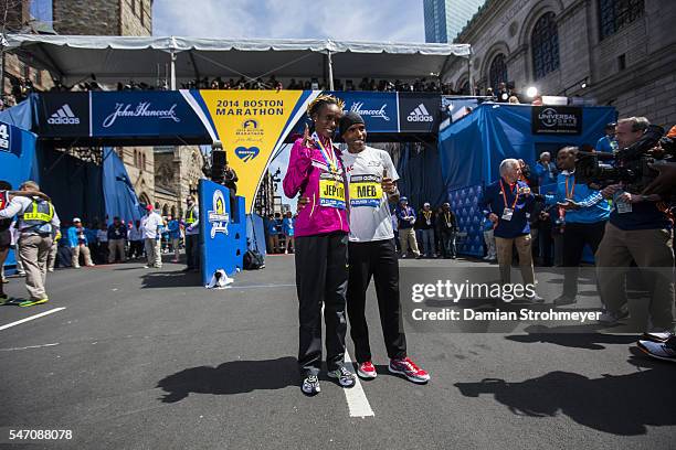 118th Boston Marathon: USA Meb Keflezighi and Kenya Rita Jeptoo victorious, posing after winning race on Boylston Street. Boston, MA 4/21/2014...