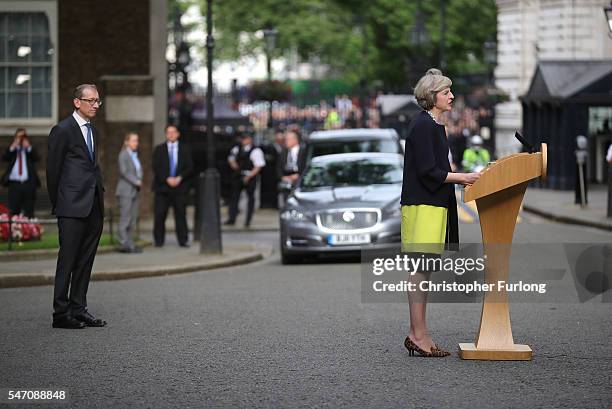 Newly appointed Prime Minister Theresa May with her husband Philip looking on speaks with the press as they arrive at 10 Downing Street on July 13,...