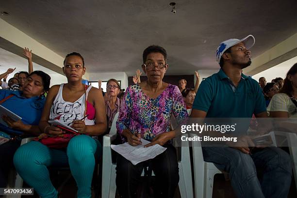Members of the Units of Battle Hugh Chavez , a subdivision of the ruling United Socialist Party of Venezuela , take notes during a CLAPs meeting in...