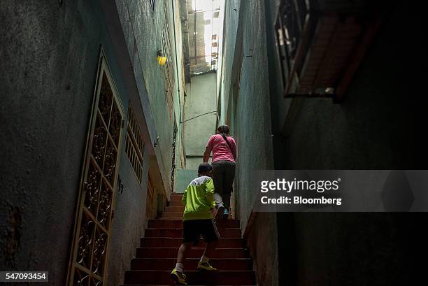 People walk up stairs towards a residence in the Catia neighborhood on the outskirts of Caracas, Venezuela, on Thursday, June 30, 2016. In an attempt...