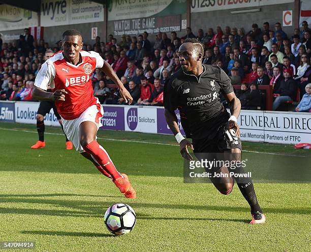 Sadio Mane of Liverpool competes with Akil Wright of Fleetwood Town during the Pre-Season Friendly match bewteen Fleetwood Town and Liverpool at...