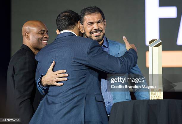 Antonio Rodrigo "Minotauro" Nogueira gets a hug from his brother Antonio Rogerio Nogueira and Anderson Silva as he is inducted into the UFC Hall of...