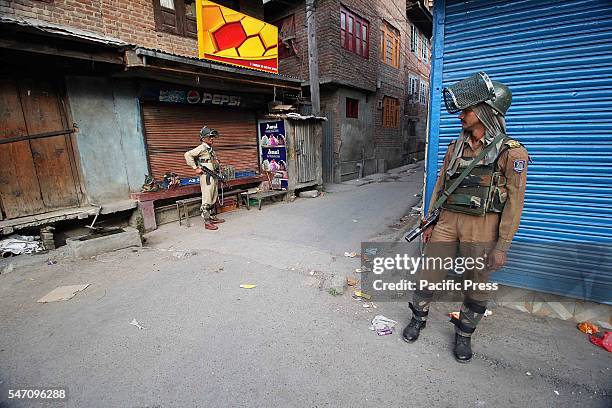 An Indian paramilitary trooper stand alert in curfew at old Srinagar the summer capital of India controlled by Kashmir.