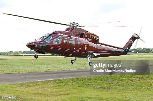 Queen Elizabeth II and Prince Philip, Duke of Edinburgh land in a Sikorsky Helicopter as they arrive to open the new East Anglian Air Ambulance base...