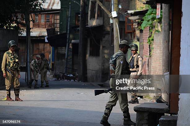 An Indian paramilitary trooper stand alert in curfew at old Srinagar the summer capital of India controlled by Kashmir.