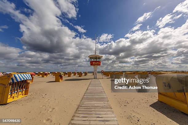 hooded beach chairs at baltic sea beach, travemünde, germany - travemuende stock pictures, royalty-free photos & images