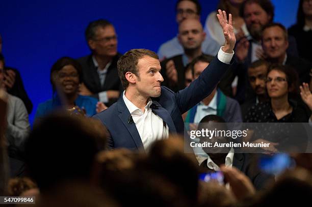 French Minister of Economic, Emmanuel Macron waves at the crowd as he arrives for the 'En Marche' political party meeting at Theatre de la Mutualite...