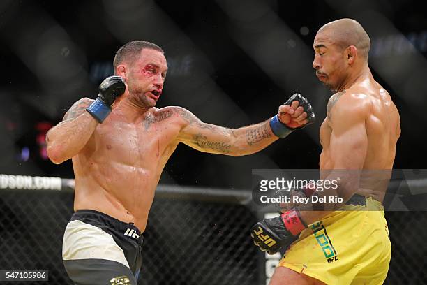 Frankie Edgar punches Jose Aldo during the UFC 200 event at T-Mobile Arena on July 9, 2016 in Las Vegas, Nevada.