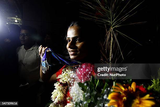 Indian spinter Dutee Chand faliciated by the public and sports students after her arrive in her home town after qualifing for the Rio Olympic at the...