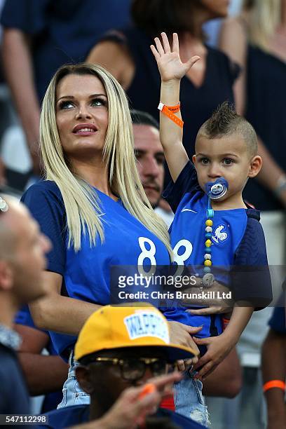 Ludivine Payet, wife of Dimitri Payet of France, looks on with her child prior to the UEFA Euro 2016 Semi Final match between Germany and France at...