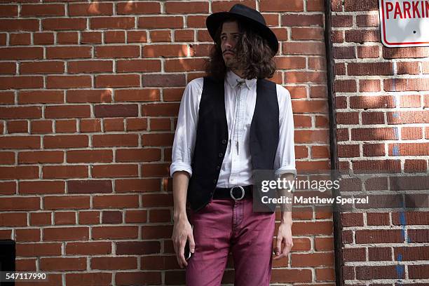 Scott Fetterman is seen attending the Industria Superstudio presentations wearing thrifted vest and hat, vintage bolo tie and watch, Brooks Brothers...