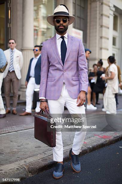 Kish is seen attending the Suitsupply Presentation wearing Brimz hat, House of Dalla jacket, shirt, tie and pants, Guidomaggi shoes, and Passavant...