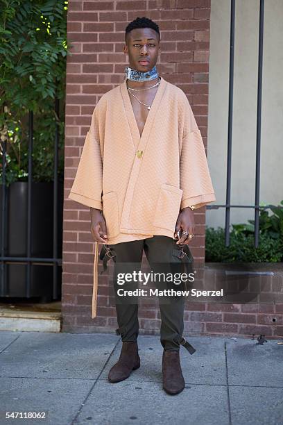 Guest is seen attending the Artistix with Andy Hilfiger Presentation wearing an Asos kimono, pants, scarf, and shoes during New York Fashion Week...