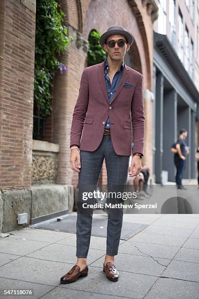 Travis Harris is seen attending the Artistix with Andy Hilfiger Presentation wearing a City Hats hat, Urban Outfitters glasses, Sand jacket, Charles...