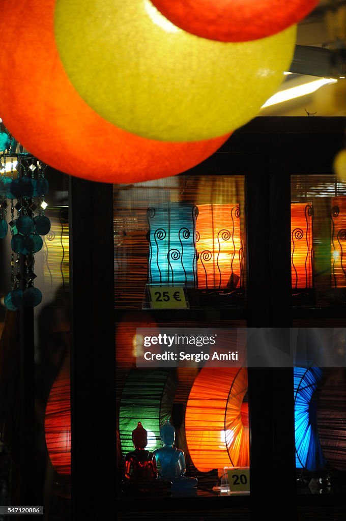 Rows of colourful lamps viewed at an angle against a dark background