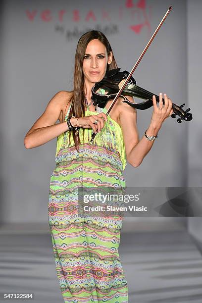 A violinist performs at Versakini x Amanda Perna Runway Show Presented By Ivy at W South Beach on July 13, 2016 in Miami Beach, Florida.