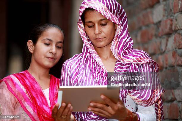 mother and daughter holding digital tablet - rural scene stock pictures, royalty-free photos & images