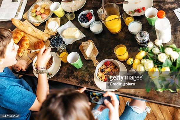 kids having breakfast together at weekend - breakfast buffet stock pictures, royalty-free photos & images