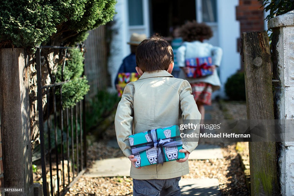 Child holding present at birthday party