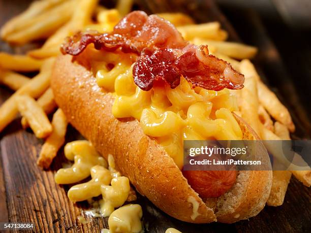 bacon mac and cheese dog with fries - hot dog stock pictures, royalty-free photos & images