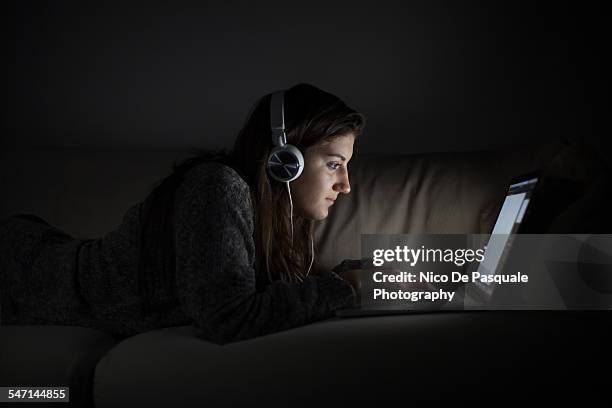 young girl using laptop - addiction mobile and laptop stock-fotos und bilder