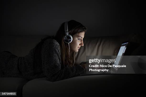 young girl using laptop - girl looking at computer foto e immagini stock