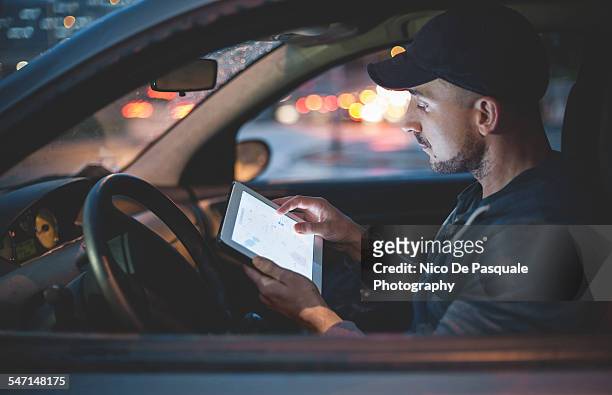 man using digital tablet - auto tablet stockfoto's en -beelden
