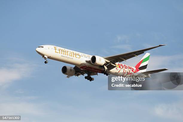 emirates aircraft on approach to land - emirates stock pictures, royalty-free photos & images