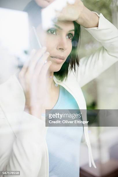 businesswoman at window - oliver eltinger stock-fotos und bilder