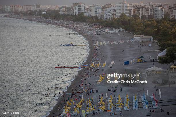 People enjoy the beach on July 13, 2016 in Antalya, Turkey. Russian President Vladimir Putin last month officially lifted travel restrictions on...