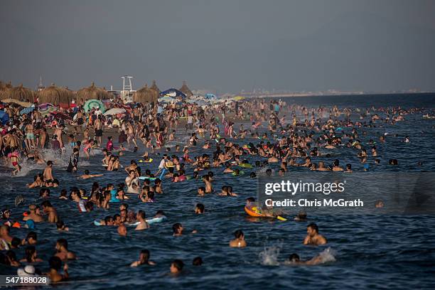 Tourists enjoy the water at a public beach on July 12, 2016 in Antalya, Turkey. Russian President Vladimir Putin last month officially lifted travel...