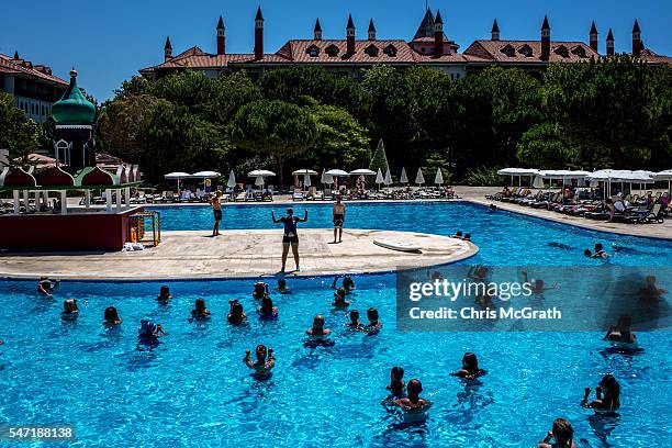 Tourists take part in an aqua aerobics session at an all inclusive Russian themed resort on July 12, 2016 in Antalya, Turkey. Russian President...