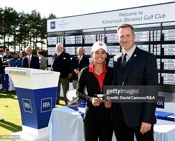 Valeria Pacheco of Puerto Rico the overall runner-up is presented with her trophy by Ewan Preston the captain of Kilmarnock Barassie Golf Club after...
