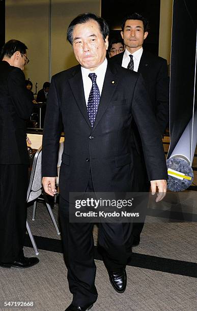 Japan - Japanese Defense Minister Yasuo Ichikawa leaves the site of his press conference in Naha, Okinawa Prefecture, in southern Japan on the night...