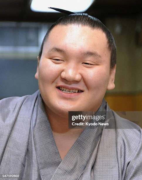 Japan - Grand champion Hakuho smiles during a news conference in Tokyo on Jan. 24 a day after capturing his sixth straight tournament title at the...