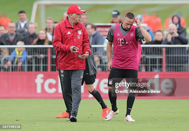 Team coach of FC Bayern Muenchen Carlo Ancelotti talks to Franck Ribery during a training session at Saebener Strasse training ground on July 14,...