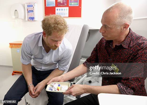 Prince Harry is shown the negative result of his HIV test taken by Specialist Psychotherapist Robert Palmer during a visit to Burrell Street Sexual...