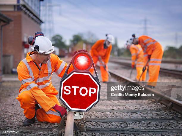 railway maintenance workers on track with stop sign - railways uk stock-fotos und bilder