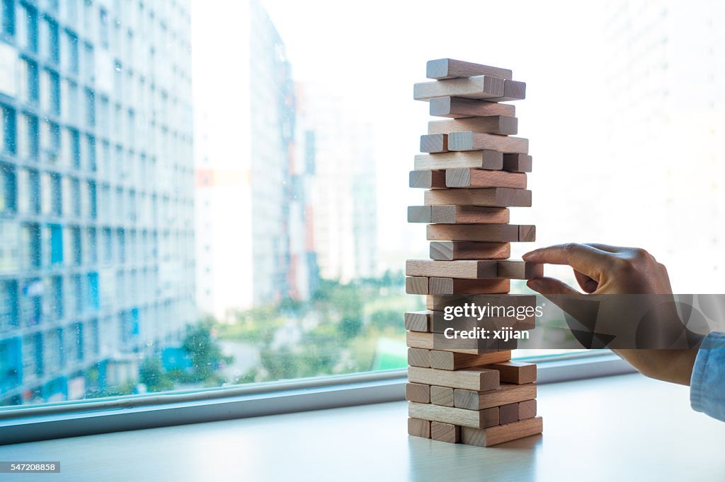 Taking one block from wooden blocks tower