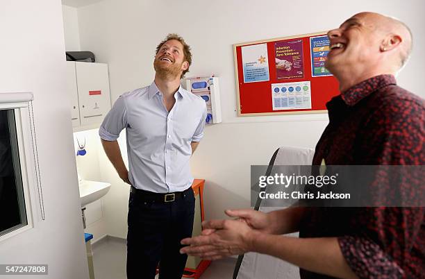 Prince Harry chats with Specialist Psychotherapist Robert Palmer as visits Burrell Street Sexual Health Clinic on July 14, 2016 in London, England....